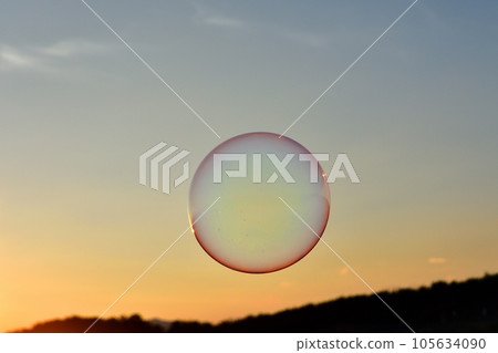 Sunset sky and round soap bubbles 105634090