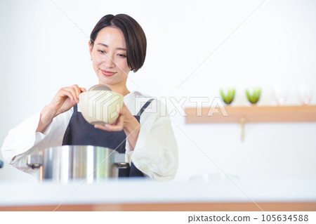 A woman making cooking A woman making cooking 105634588