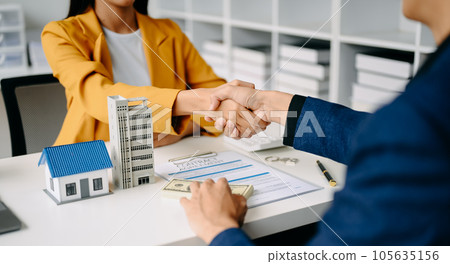 Buying a home or insurance deal, an insurance agent pointing a pen to those interested in renting a house, a contract, signing an Home buying agreement in modern office. Buying a home or insurance deal, an insurance agent pointing a pen to those interested in renting a house, a contract, signing an Home buying agreement in modern office. 105635156