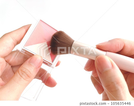 Woman's hand with blush and makeup brush Woman's hand with blush and makeup brush 105635446