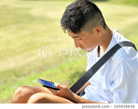 boy playing games on smartphone boy playing games on smartphone 105636636