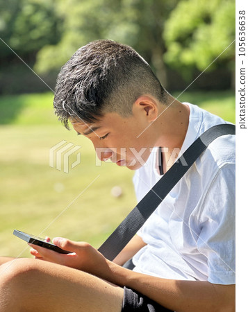 boy playing games on smartphone boy playing games on smartphone 105636638