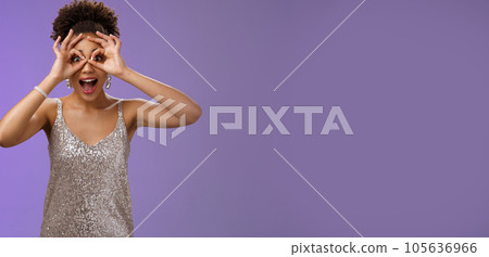 Impressed thrilled joyful african-american woman cannot believe own luck look through circles okay gesture eyes open mouth astonished speechless stare camera fascinated, excited blue background 105636966
