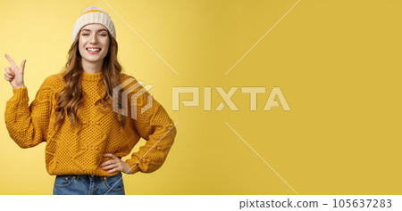 Confident fashionable 20s girl proudly smiling hold hand waist self-assured pointing upper left corner showing perfect copy space top advertisement, promoting product grinning delighted Confident fashionable 20s girl proudly smiling hold hand waist self-assured pointing upper left corner showing perfect copy space top advertisement, promoting product grinning delighted 105637283
