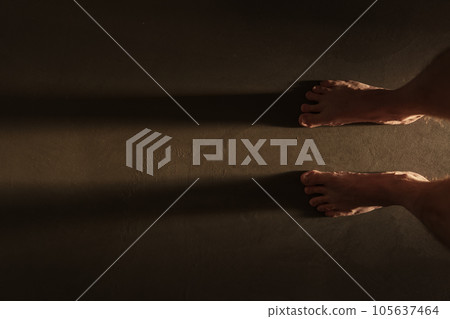 Man legs indoor shot with long shadow during sunrise Man legs indoor shot with long shadow during sunrise 105637464