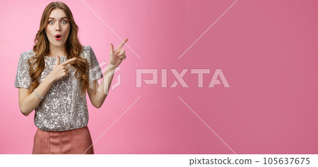Amused attractive european woman see awesome promo pointing upper right corner sideways thrilled say wow folding lips astonished excited widen eyes impressed surprised, standing pink background Amused attractive european woman see awesome promo pointing upper right corner sideways thrilled say wow folding lips astonished excited widen eyes impressed surprised, standing pink background 105637675