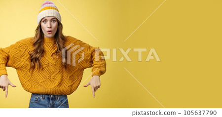 Wow stunning promo. Amused surprised good-looking stylish glamour young woman promoting interesting copy space folding lips amazed widen eyes pointing index fingers down bottom advertisement 105637790
