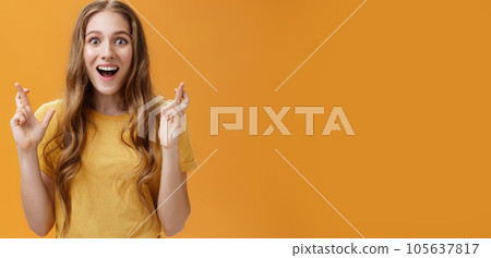 Waist-up shot of interested amused and enthusiastic good-looking woman in casual t-shirt crossing fingers for good luck smiling amazed and delighted being happy and hopeful things will be well Waist-up shot of interested amused and enthusiastic good-looking woman in casual t-shirt crossing fingers for good luck smiling amazed and delighted being happy and hopeful things will be well 105637817