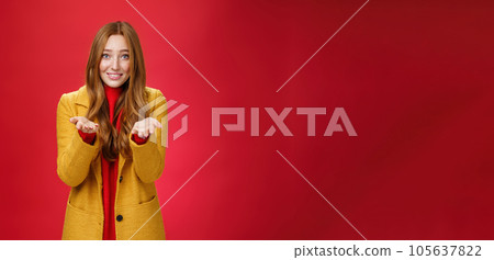Girl with tender and caring expression smiling extanding hands forward as giving thanks or pointing at someone special feeling admiration thanking partner for support, confessing in love and sympathy 105637822