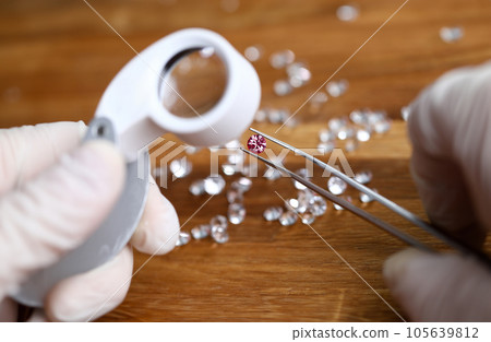 Jeweler checking gem for identity Jeweler checking gem for identity 105639812
