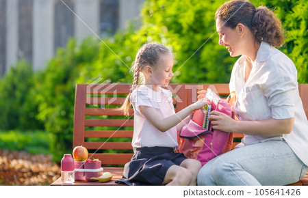 Parent and kid going to school 105641426