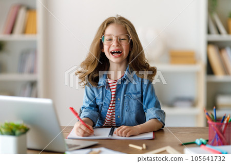 Girl doing homework or online education. Girl doing homework or online education. 105641732