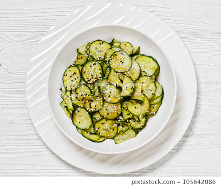 Sunomono, Japanese Cucumber Salad in a white bowl 105642086