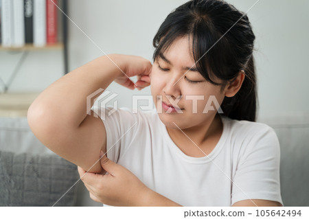 Close up of Chubby woman pinching upper arm fat. weight loss concept. Close up of Chubby woman pinching upper arm fat. weight loss concept. 105642494