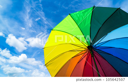 Colorful rainbow umbrella on blue sky background. LGBT, Pride Month, diversity, Sunprotect Concept. 105642507