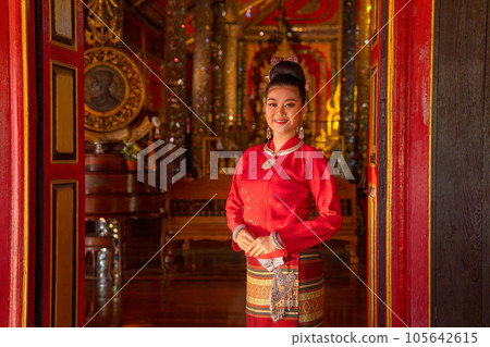 Portrait of young Asian woman wear Thai Lanna traditional dress stand in front door of building Portrait of young Asian woman wear Thai Lanna traditional dress stand in front door of building 105642615