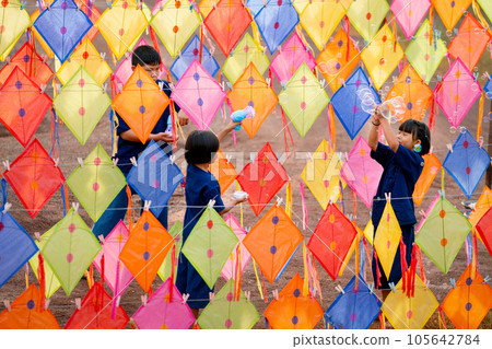 Three Asian boy and girl enjoy to play with bubble that create from bubble gun and happy playing Three Asian boy and girl enjoy to play with bubble that create from bubble gun and happy playing 105642784