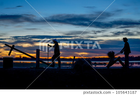 Silhouette of Asian man use Thai rice crackers and other work in the back with using local tools 105643187