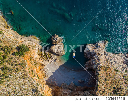 Top view of a beautiful sea harbor. Lagoon with dark blue water. Waves near rocky coast Top view of a beautiful sea harbor. Lagoon with dark blue water. Waves near rocky coast 105643216