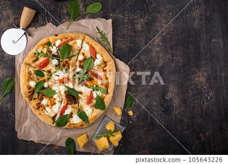 Italian pizza with feta cheese, tomato and basil 105643226