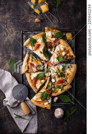 Italian pizza with feta cheese, tomato and basil Italian pizza with feta cheese, tomato and basil 105643234