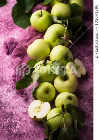 Fresh ripe green apple in purple background. Fresh ripe green apple in purple background. 105643296