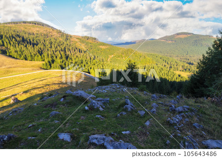 mountainous carpathian countryside in autumn. forested hills rolling down in to the distant rural valley. beautiful scenery on a sunny day with clouds on the sky mountainous carpathian countryside in autumn. forested hills rolling down in to the distant rural valley. beautiful scenery on a sunny day with clouds on the sky 105643486