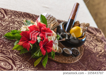 product photography for wellness and cosmetics, preparations and tools for massage, decorated with flowers, Asian massage in a tropical environment 105643787