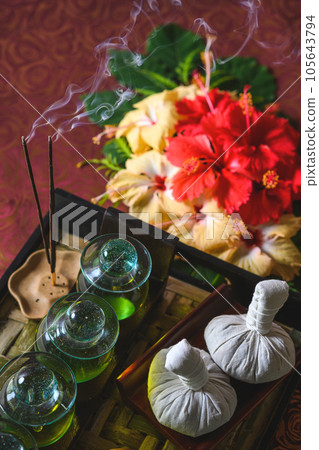 product photography for wellness and cosmetics, preparations and tools for massage, decorated with flowers, Asian massage in a tropical environment product photography for wellness and cosmetics, preparations and tools for massage, decorated with flowers, Asian massage in a tropical environment 105643794
