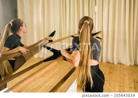 Ballerina in pointe pose. Beautiful ballet dancer stretching in class. Ballerina woman training Ballerina in pointe pose. Beautiful ballet dancer stretching in class. Ballerina woman training 105643839