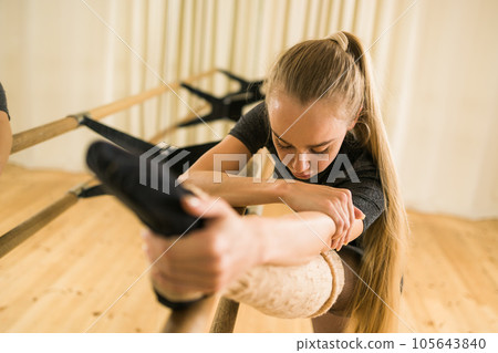 Ballerina in pointe pose. Beautiful ballet dancer stretching in class. Ballerina woman training 105643840