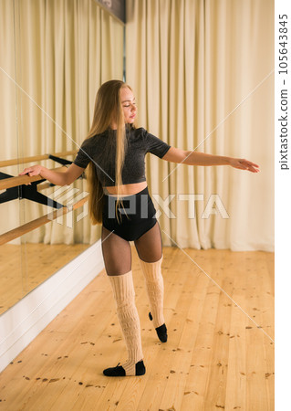Ballerina in pointe pose. Beautiful ballet dancer stretching in class. Ballerina woman training 105643845