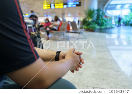 Man waiting for flight in airport departure area at airport waiting the flight Man waiting for flight in airport departure area at airport waiting the flight 105643847