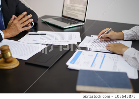 Legal counsel presents to the client a signed contract with gavel and legal law. justice and lawyer concept Legal counsel presents to the client a signed contract with gavel and legal law. justice and lawyer concept 105643875