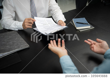 Examiner reading a resume during job interview at office Business and human resources concept. 105643888