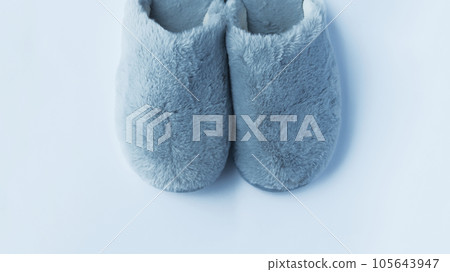 Woman blue wool fluffy warm-lined slippers isolated on white. Woman blue wool fluffy warm-lined slippers isolated on white. 105643947