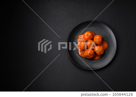 Delicious fresh meatballs in tomato sauce with salt, spices and herbs Delicious fresh meatballs in tomato sauce with salt, spices and herbs 105644128