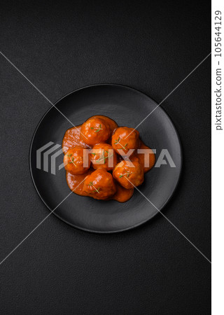 Delicious fresh meatballs in tomato sauce with salt, spices and herbs Delicious fresh meatballs in tomato sauce with salt, spices and herbs 105644129