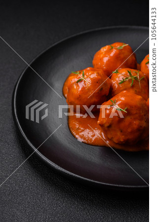Delicious fresh meatballs in tomato sauce with salt, spices and herbs 105644133