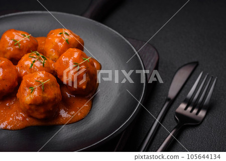 Delicious fresh meatballs in tomato sauce with salt, spices and herbs 105644134