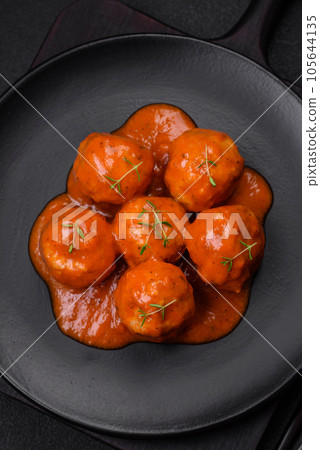 Delicious fresh meatballs in tomato sauce with salt, spices and herbs 105644135