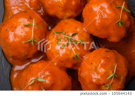 Delicious fresh meatballs in tomato sauce with salt, spices and herbs 105644143