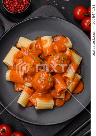 Delicious fresh meatballs and pasta in tomato sauce with salt, spices and herbs 105644151