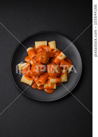 Delicious fresh meatballs and pasta in tomato sauce with salt, spices and herbs 105644166