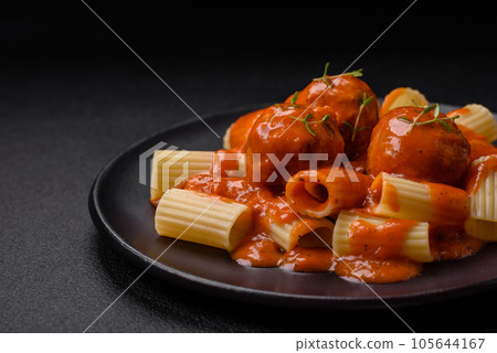 Delicious fresh meatballs and pasta in tomato sauce with salt, spices and herbs 105644167