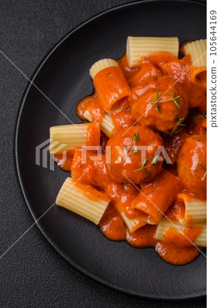 Delicious fresh meatballs and pasta in tomato sauce with salt, spices and herbs 105644169