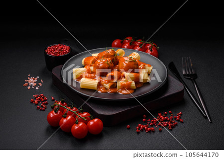 Delicious fresh meatballs and pasta in tomato sauce with salt, spices and herbs 105644170