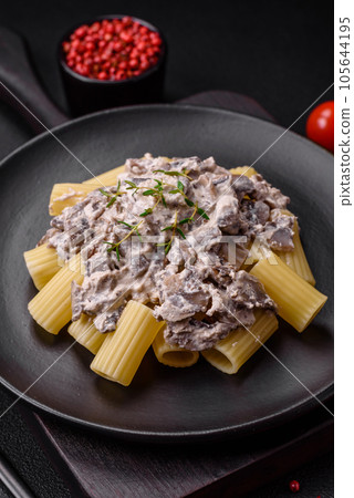 Delicious fresh pasta with champignon mushrooms in a creamy sauce Delicious fresh pasta with champignon mushrooms in a creamy sauce 105644195