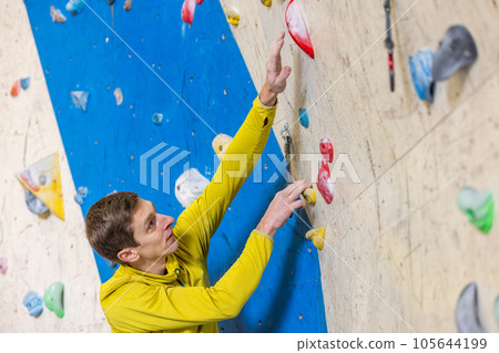 Young climber climbing indoor wall, sport concept 105644199