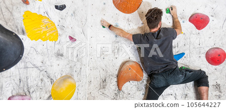 Young climber climbing indoor wall, sport concept 105644227